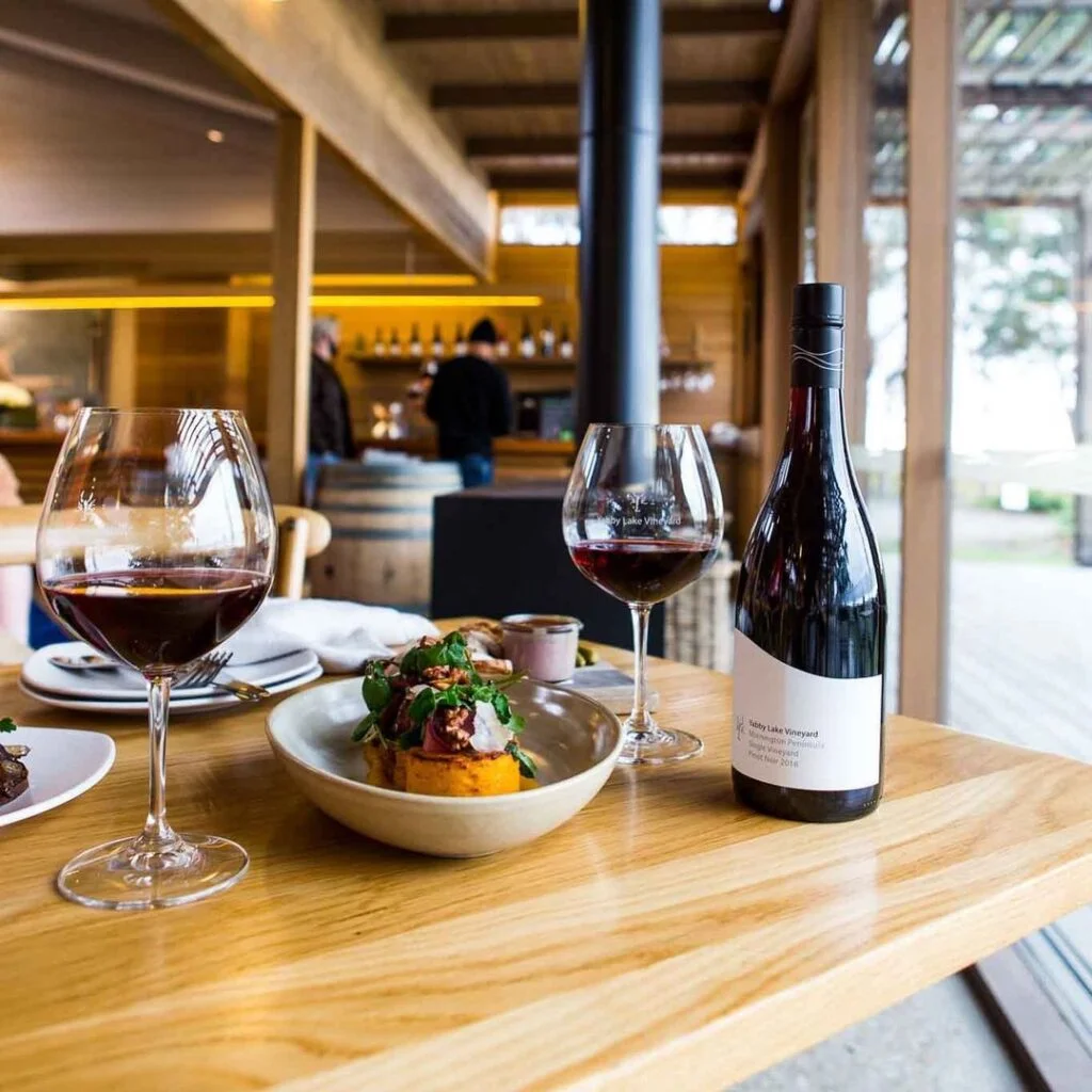 Wine Bottle, Wine Glasses With Foods At Yabby Lake Winery Restaurants In Mornington Peninsula