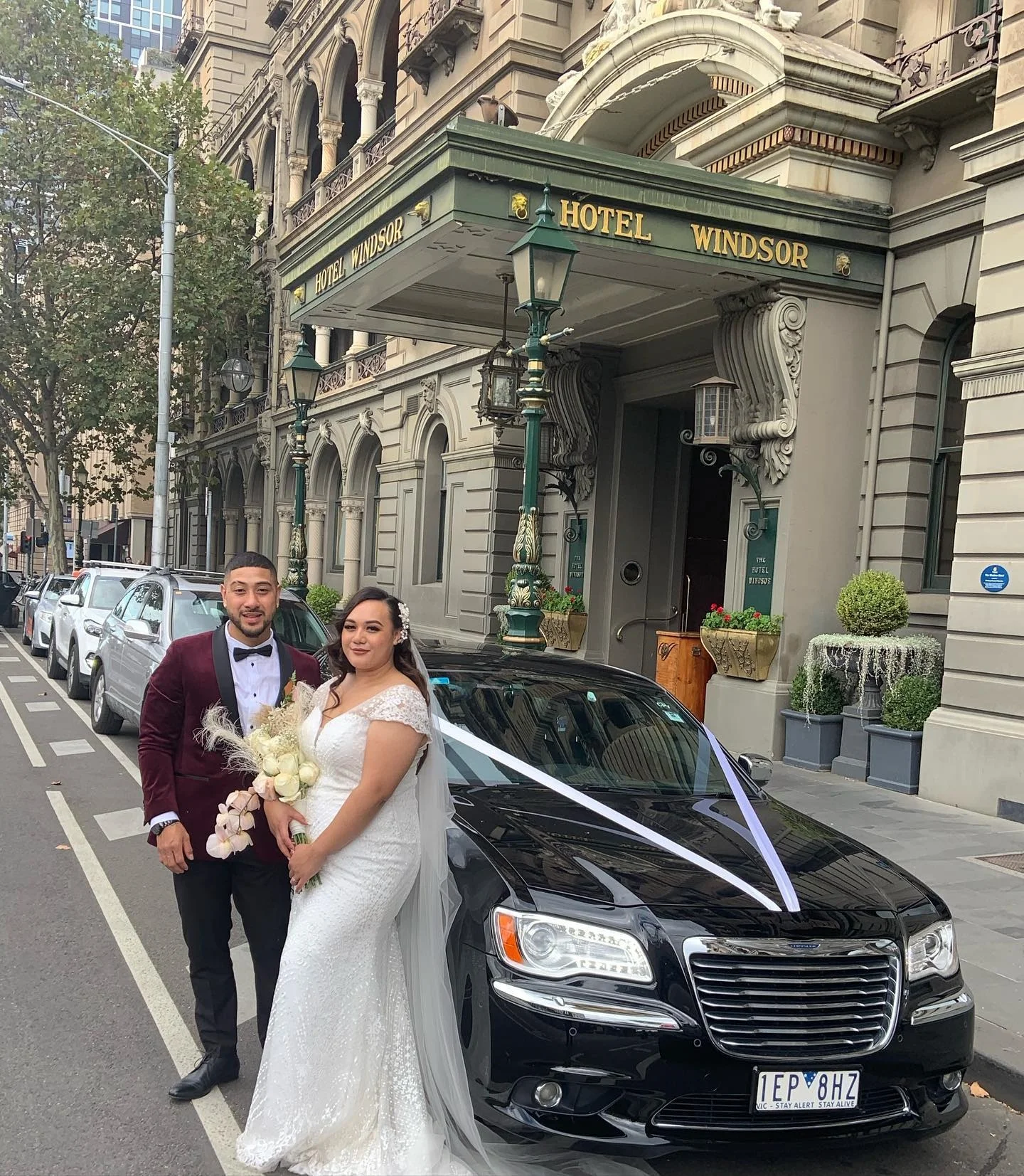 Couple Stay Near Their Wedding Transport
