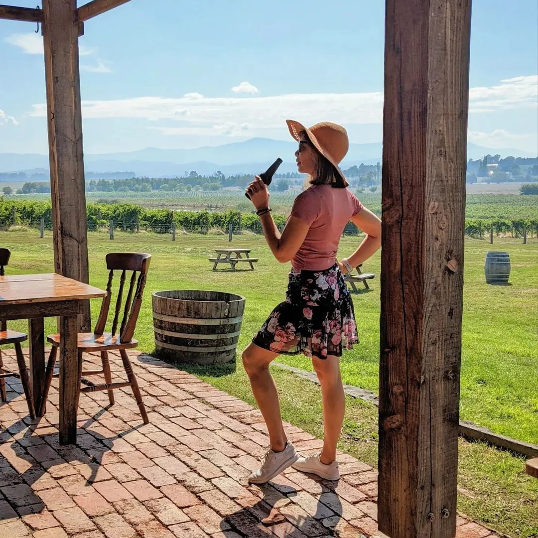 Girl Tasting Wine Bottle In Yering Farm With Ami Tours Australia