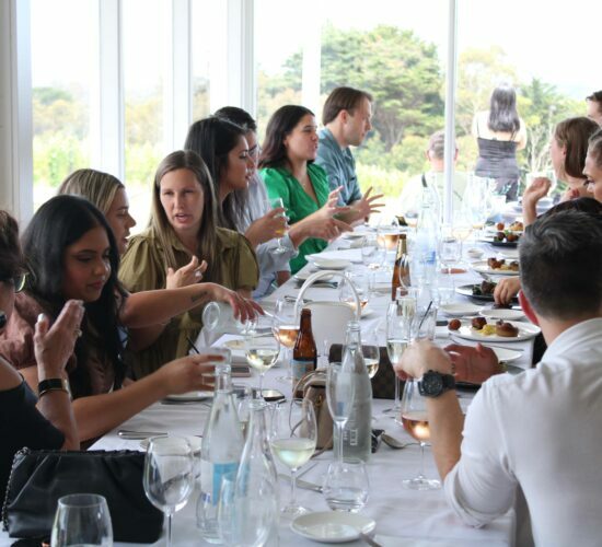 Team members are having a chat while tasting wines and foods in Yarra valley winery restaurants