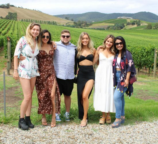 Wine lovers visiting vineyard during their wine tour