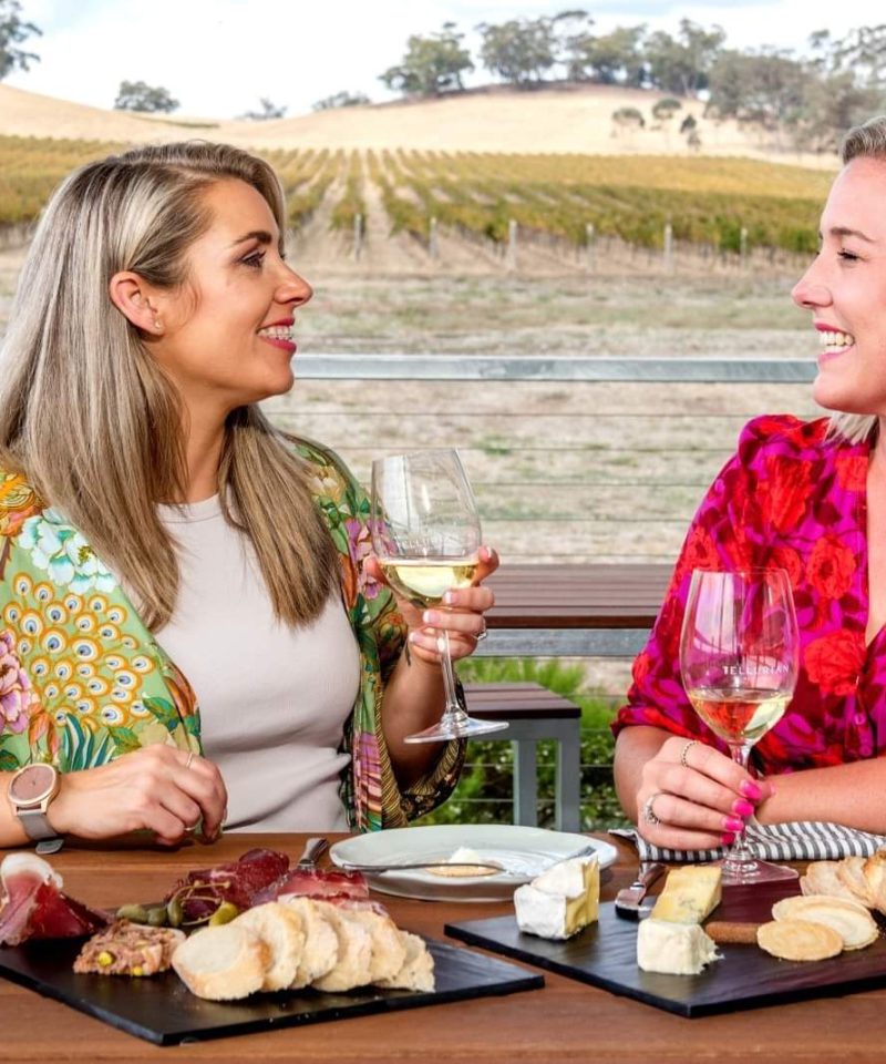 Two Women Enjoy Wines At Wineries In Heathcote